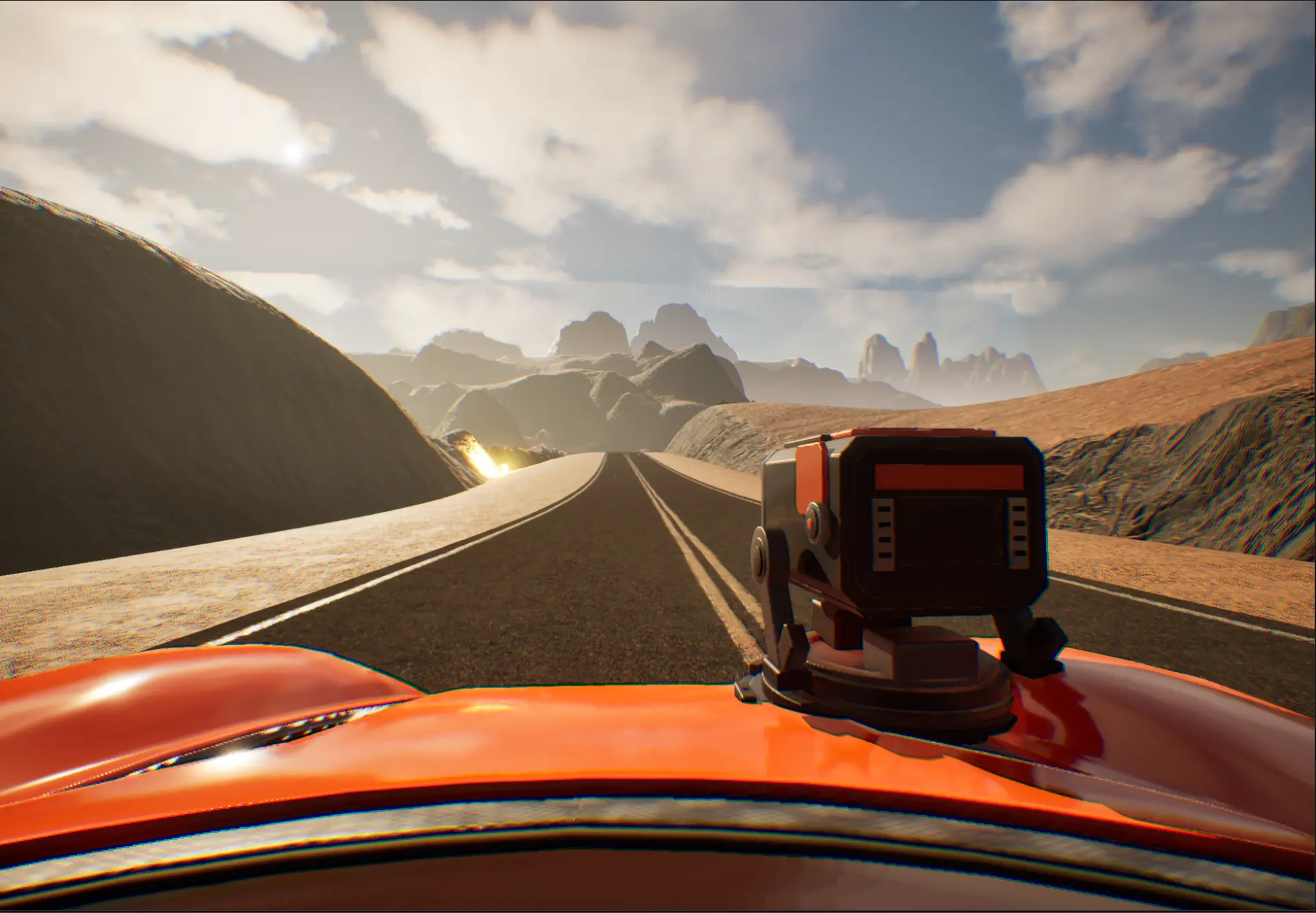 View over the orange car and its mounted weapon on a desert road